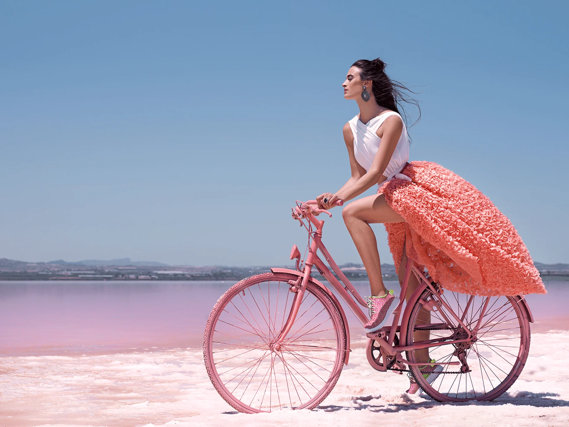 Model on a pink bicycle in a pink landscape — Pink Dreams