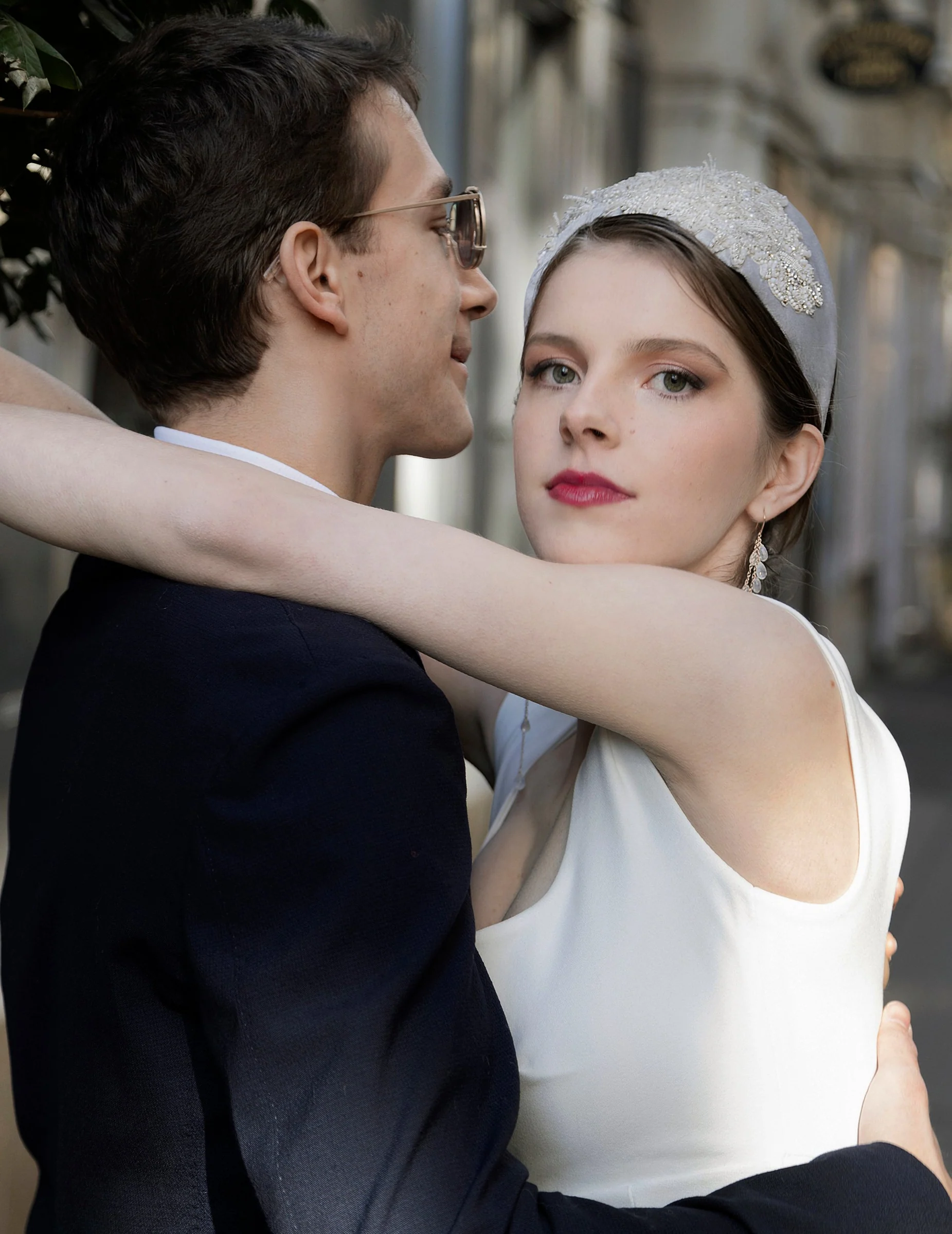 Bride looking towards the camera in an embrace